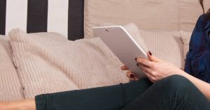 Girl with iPad researching Mortgage